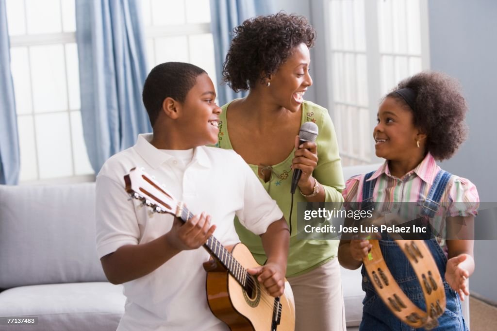 African American mother and children playing instruments