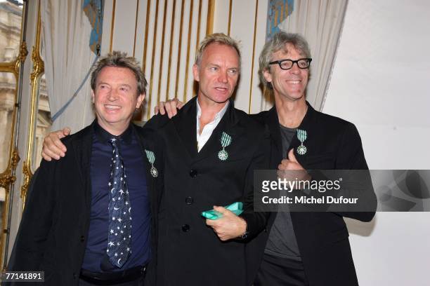 Andy Summers, Sting, Steward Copeland pose as The Police members are inducted as 'Knights in the Order of Arts and Letters' at the Ministry of...