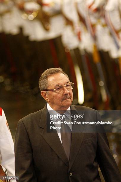 Raul Castro, Cuba's acting President and brother of Fidel Castro, walks past the Guards of Honor during the official welcome ceremony for Joao...