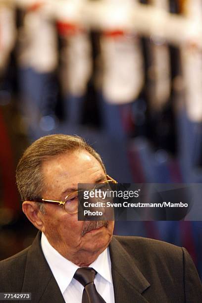 Raul Castro, Cuba's acting President and brother of Fidel Castro, walks past the Guards of Honor during the official welcome ceremony for Joao...