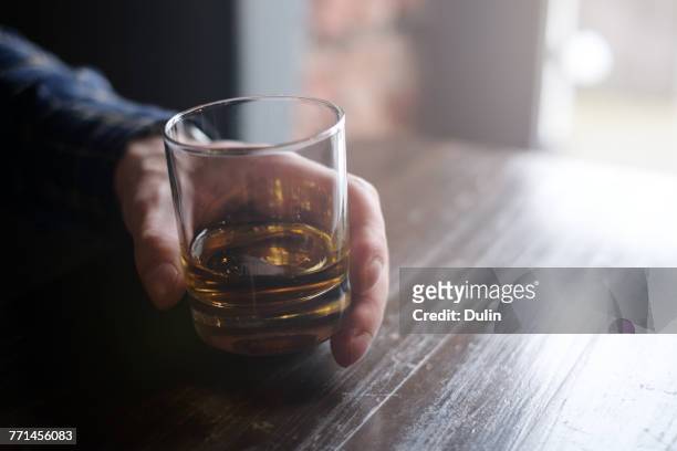 man holding glass of whisky - scotch whisky stock-fotos und bilder