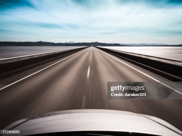 view from top of a car speeding along a bridge, megler, washington, america, usa  - vehicle hood stock-fotos und bilder