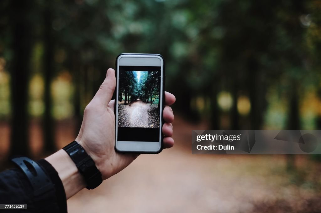 Man taking a photo with a smartphone