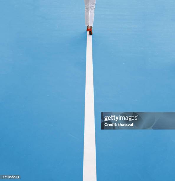 woman walking along a straight line - simplicity concept imagens e fotografias de stock