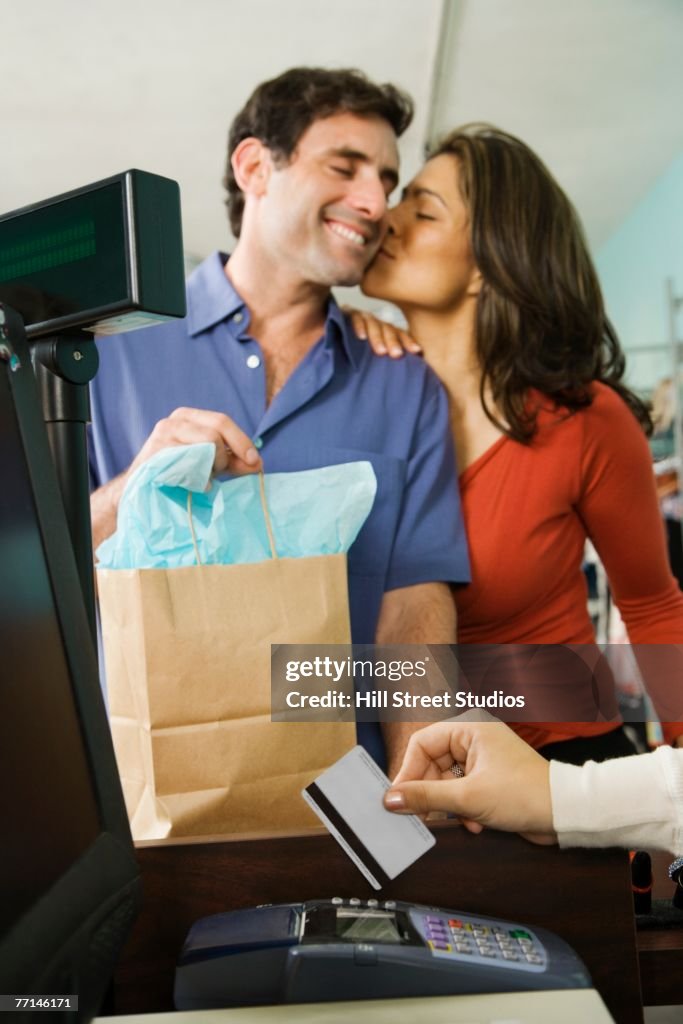 Hispanic couple shopping in clothing store
