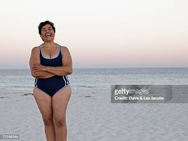 mixed race woman on beach - old woman in swimsuit stock pictures, royalty-free photos & images