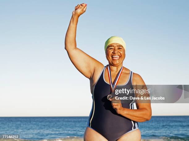 mixed race woman with medal on beach - ellis island medals of honor awards december 9 1990 stockfoto's en -beelden