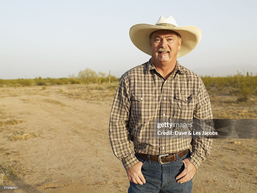 Mixed Race man wearing cowboy hat