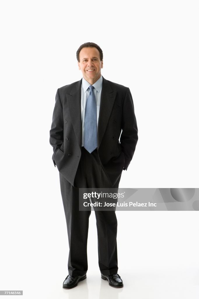 Hispanic businessman with hands in pockets