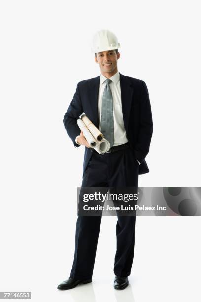 hispanic businessman holding blueprints - architect object stock pictures, royalty-free photos & images