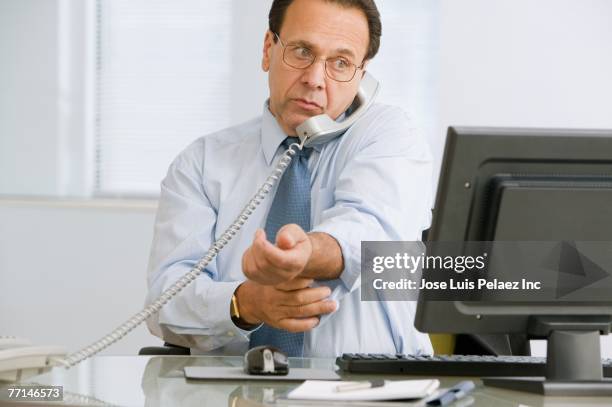 hispanic businessman talking on telephone - roll call stock pictures, royalty-free photos & images