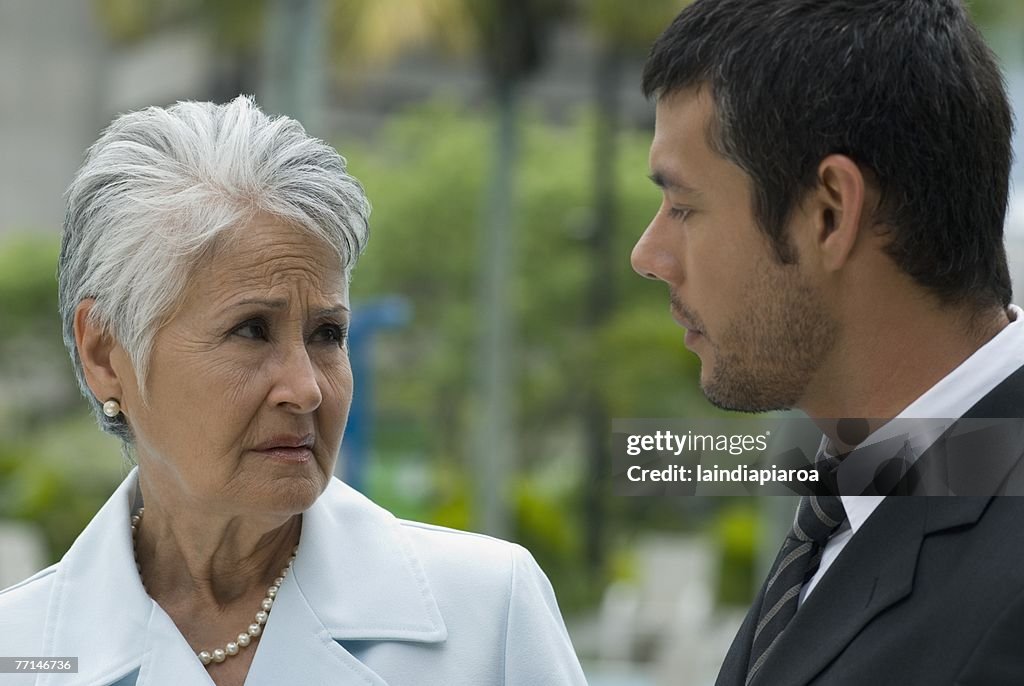 Hispanic mother and adult son talking