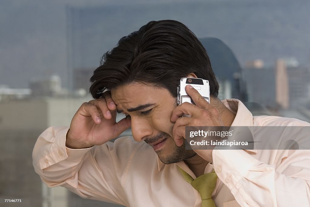 Hispanic businessman talking on cell phone