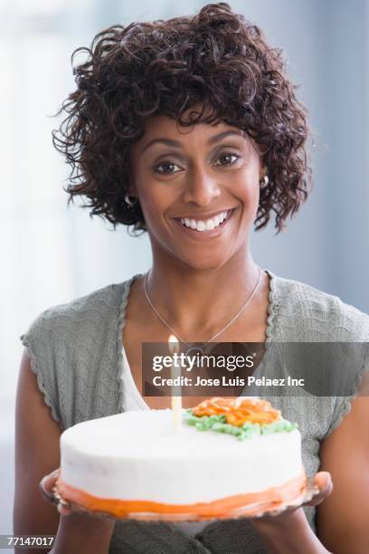 african american woman holding birthday cake - woman birthday stock pictures, royalty-free photos & images