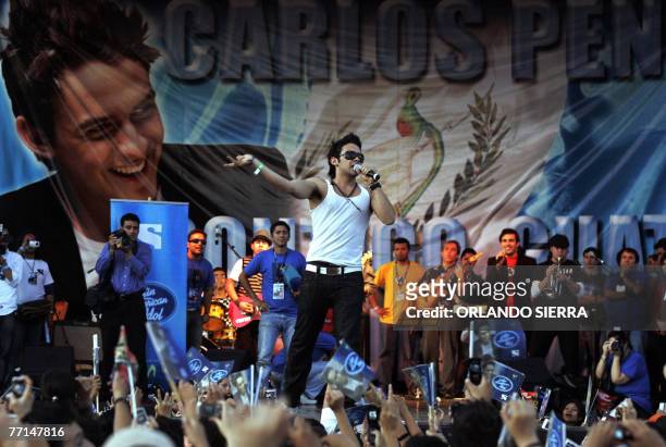 The winner of the TV contest Latin American Idol, Guatemalan pop singer Carlos Pena, performs at the Constitution square in Guatemala City on October...