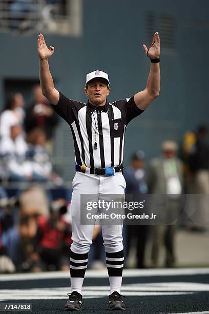 Referee Ed Hochuli signals during the Seattle Seahawks game against the Cincinnati Bengals at Qwest Field on September 23, 2007 in Seattle,...