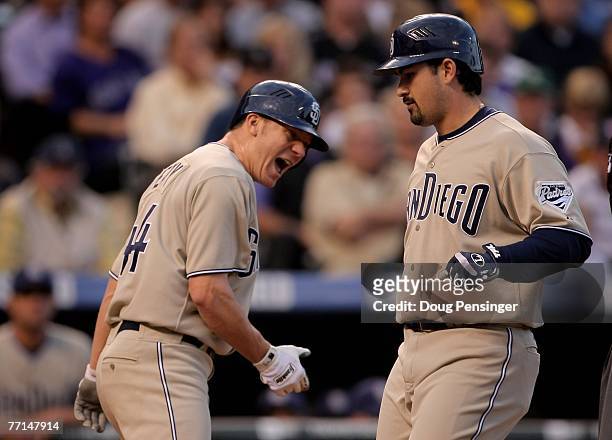 Adrian Gonzalez of the San Diego Padres crosses the plate after hitting a grand slam home run off of Josh Fogg of the Colorado Rockies as Jake Peavy...