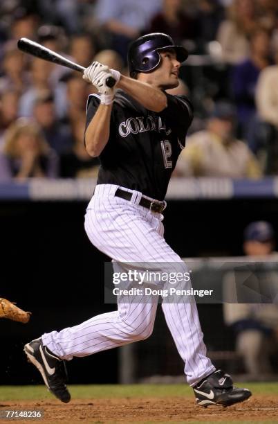 Seth Smith of the Colorado Rockies follows through on his pinch-hit triple off of Jake Peavy of the San Diego Padres in the sixth inning at Coors...