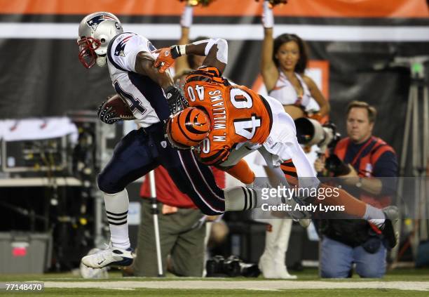 Sammy Morris of the New England Patriots runs with the ball while Madieu Williams of the Cincinnati Bengals reaches for him during the NFL game on...