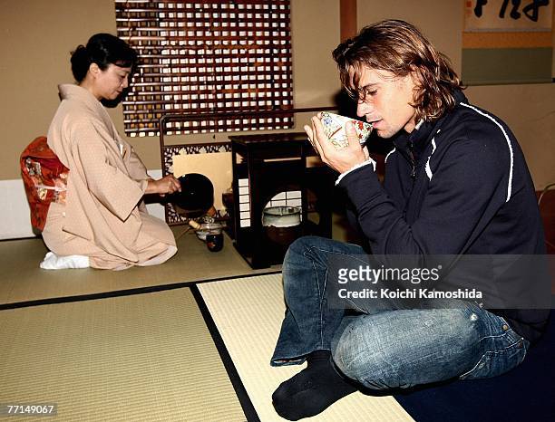 David Ferrer of Spain tries Japanese tea at the Toko-An Teahouse in Imperial Hotel during day two of the AIG Japan Open Tennis Championships held at...