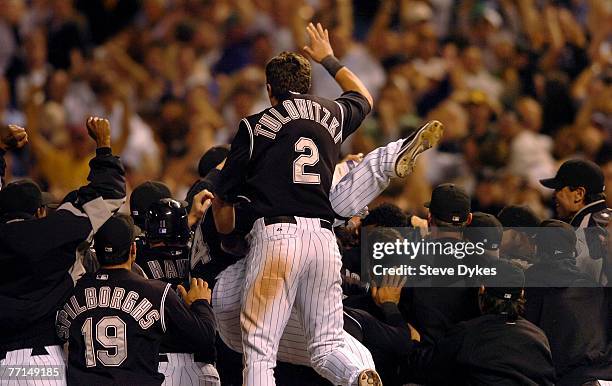 Troy Tulowitzki of the Colorado Rockies jumps into the pile as he celebrates his teams wild card playoff baseball victory over the San Diego Padres...