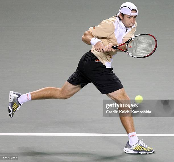 Benjamin Becker of Germany hits a return shot against Takao Suzuki of Japan during day two of the AIG Japan Open Tennis Championships held at Ariake...