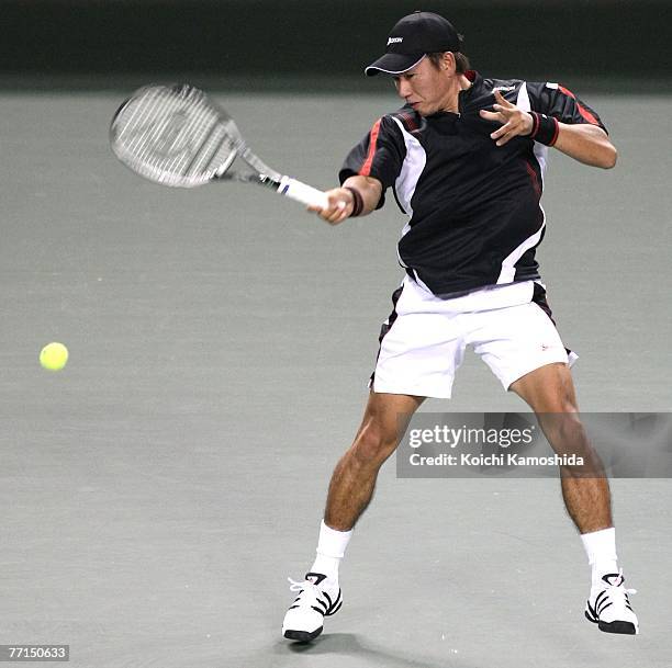 Takao Suzuki of Japan hits a return shot against Benjamin Becker of Germany during day two of the AIG Japan Open Tennis Championships held at Ariake...