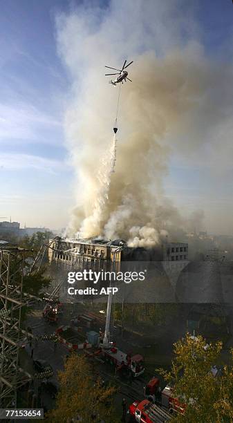 Fire-brigade helicopter dumps water on the dormitory of the Moscow Institute of State and Corporate Governance in Moscow, 02 October 2007. At least...