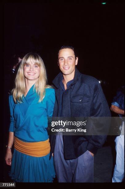 Singer Olivia Newton-John and husband Matt Lattanzi smile at the ECO benefit premiere of the film "Look Who's Talking" October 12, 1989 in Los...