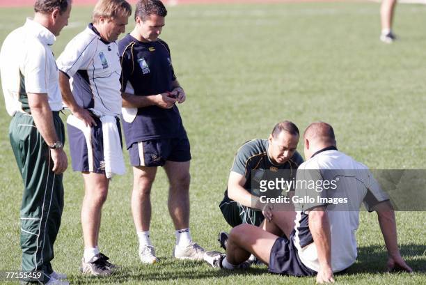 Jake White, Derick Coetzee, Clint Readhead and Dr Yussuf Hasan tends to injured CJ van der Linde during the South Africa training session at the...