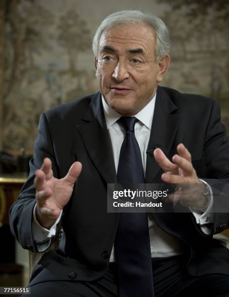 In this handout photo supplied by the International Monetary Fund , Former French Finance Minister Dominique Strauss-Kahn and newly appointed...