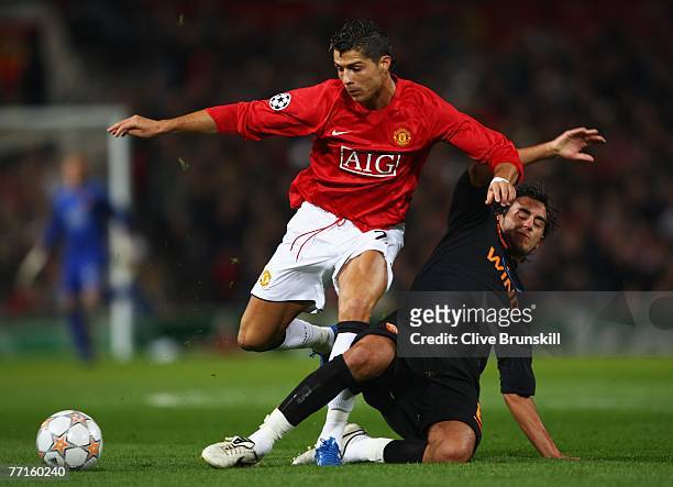 Cristiano Ronaldo of Manchester United is tackled by Alberto Aquilani of AS Roma during the UEFA Champions League Group F match between Manchester...
