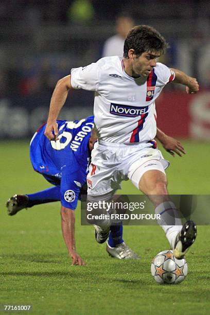 Lyon's midfielder Juninho Pernambucano vies with Glasgow Rangers' forward Daniel Cousin during their UEFA Champions League Group E match at Gerland'...