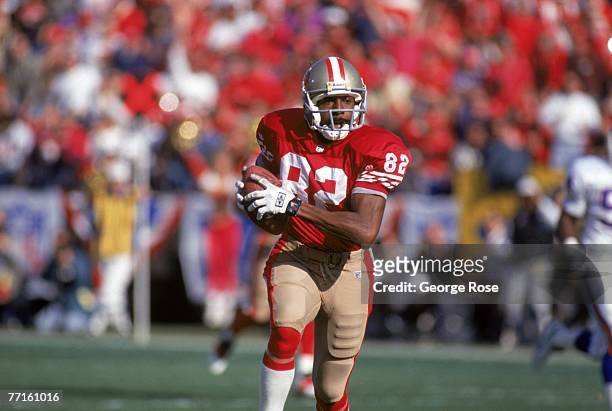 Wide receiver John Taylor of the San Francisco 49ers runs with the ball during the 1993 NFC Championship game against the New York Giants at...