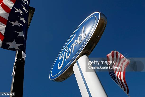 American flags fly near a sign at a Ford delership October 2, 2007 in Colma, California. Ford reported today a 21 percent decline in September sales...