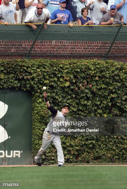 Nate McLouth of the Pittsburgh Pirates throws the ball by Ryan Theriot of the Chicago Cubs as fans jeer him at Wrigley Field September 21, 2007 in...