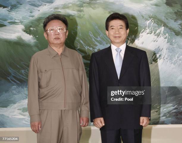 South Korea's President Roh Moo-Hyun and North Korea's leader Kim Jong-Il pose for a commemorative photograph in the Baekhwawon State guesthouse...