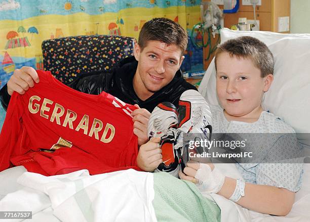 Liverpool captain Steven Gerrard poses with 10 year old Jamie Hellawell at Liverpool's Alder Hey Hospital, following a road traffic collision in...