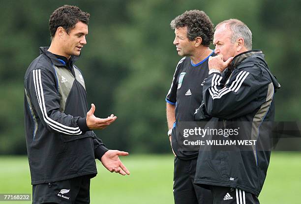 New Zealand All Black flyhalf Daniel Carter chats to assistant coach Wayne Smith and coach Graham Henry as Carter recovers from an injury during...