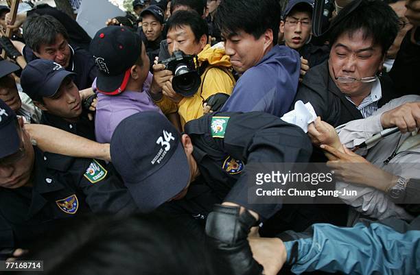 South Korean protestersclash with riot police officers as they try to burn North Korean flags during an anti Korea Summit rally on October 3, 2007 in...
