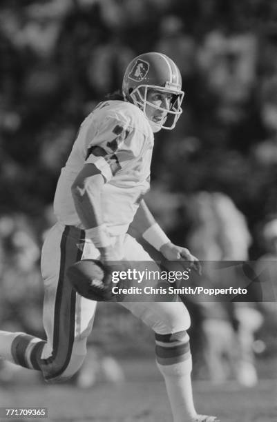 American football quarterback John Elway pictured in action making a run with the ball for Denver Broncos against Los Angeles Raiders at Los Angeles...