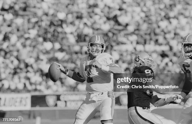 American football quarterback John Elway pictured in action passing the ball downfield for Denver Broncos against Los Angeles Raiders at Los Angeles...