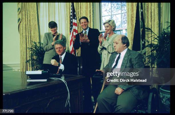 James Brady, Sarah Brady, Al Gore, Janet Reno, and Bill Clinton celebrate the Senate's passing of the Brady Bill November 24, 1983 at the White...