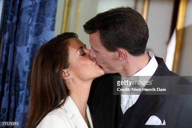Prince Joachim of Denmark and Marie Cavallier kiss during a press conference to announce their engagement, at the Riddersalen of the Amalienborg...