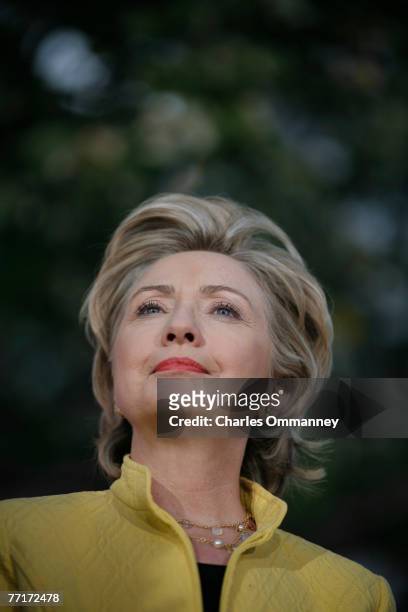 Democratic presidential hopeful Sen. Hillary Rodham Clinton speaks while former US President Bill Clinton listens at a fall kick-off campaign rally,...