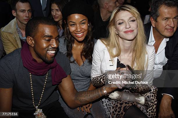 Rapper Kanye West and his fiance Alexis Phifer, Courtney Love and fashion photographer Mario Testino attend the Givenchy fashion show during the...