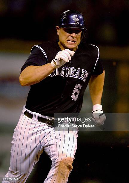 Matt Holliday of the Colorado Rockies chugs around second base on his way to third base in the 13th inning of the Rockies victory over the San Diego...