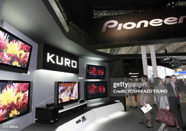 Visitors looks at high-definition plasma display panel TVs of Japan's electronics giant Pioneer, called "Kuro" or black in Japanese, at Asia's...