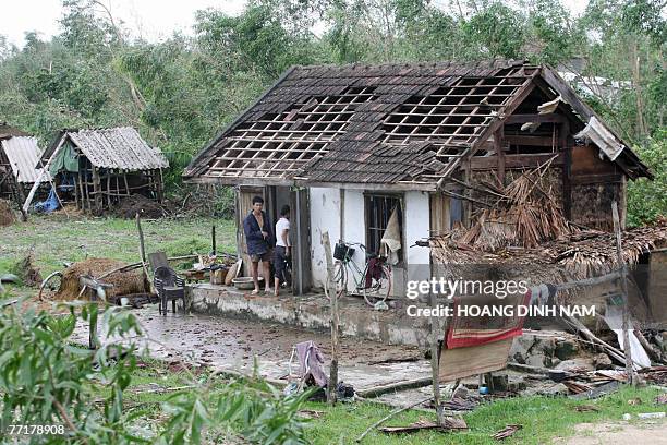 Couple stand at their damaged house after the passage of the tropical storm Lekima at Cam Xuyen district, in the central province of Ha Tinh, 04...