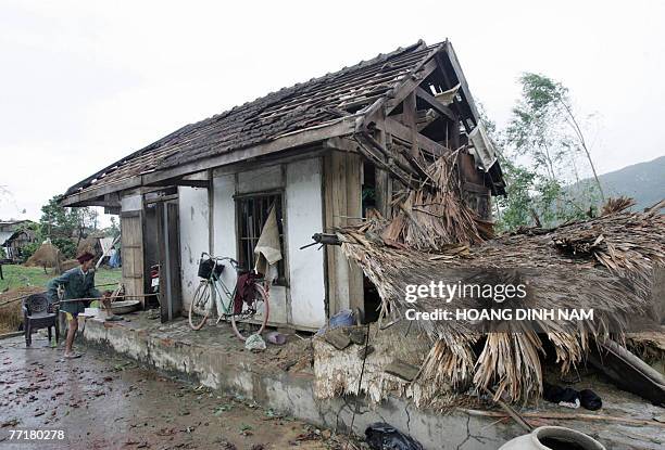 Man cleans up his damaged house after the passage of the tropical storm Lekima, at Cam Xuyen district, in the central province of Ha Tinh on 04...
